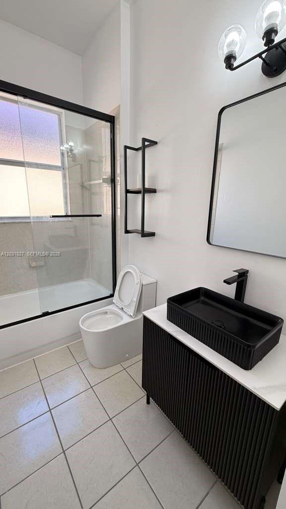 2120 Northeast 37th Road, Unit 1 Homestead, FL 33033 - Photo 23 of 30 a bathroom with a sink a toilet and mirror