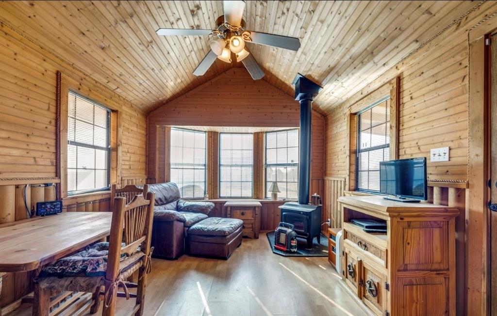 586 Pleasant Home Road Sherman, TX 75092 - Photo 20 of 25 a living room with furniture a fireplace and large windows