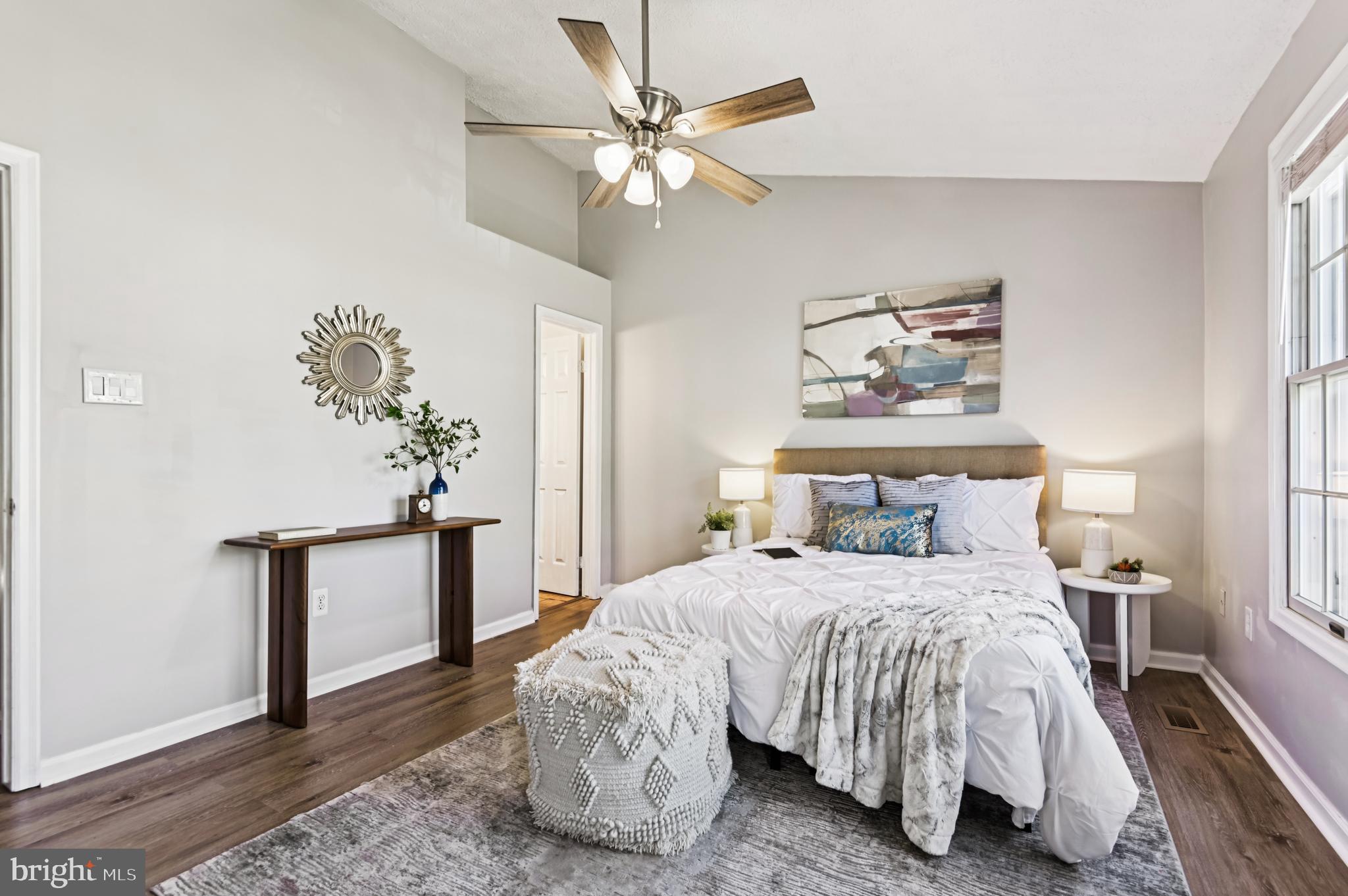 19 Championship Court, Unit K5 Owings Mills, MD 21117 - Photo 16 of 35 a bedroom with a large bed and a chandelier