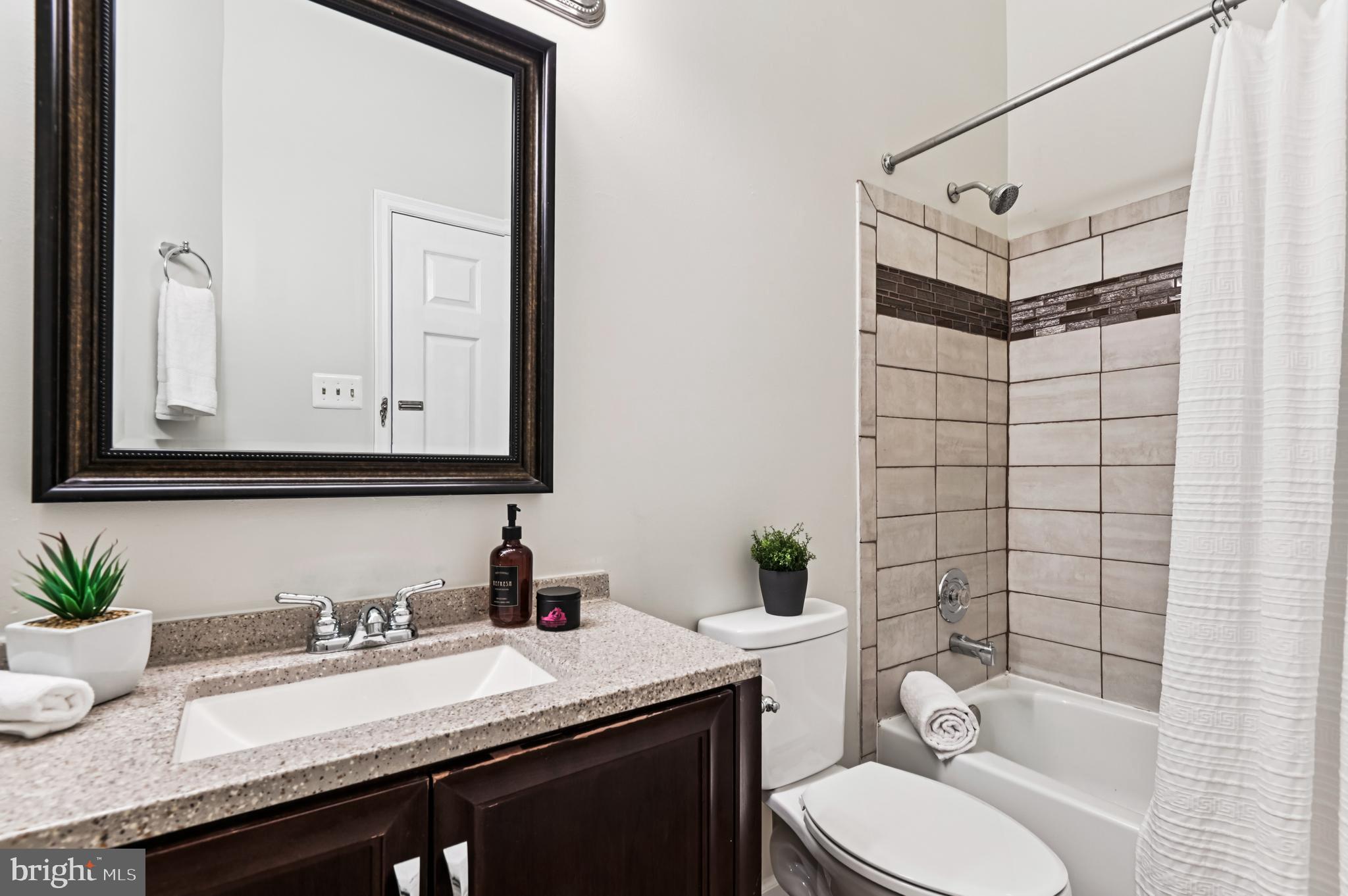 19 Championship Court, Unit K5 Owings Mills, MD 21117 - Photo 21 of 35 a bathroom with a granite countertop sink mirror vanity and toilet