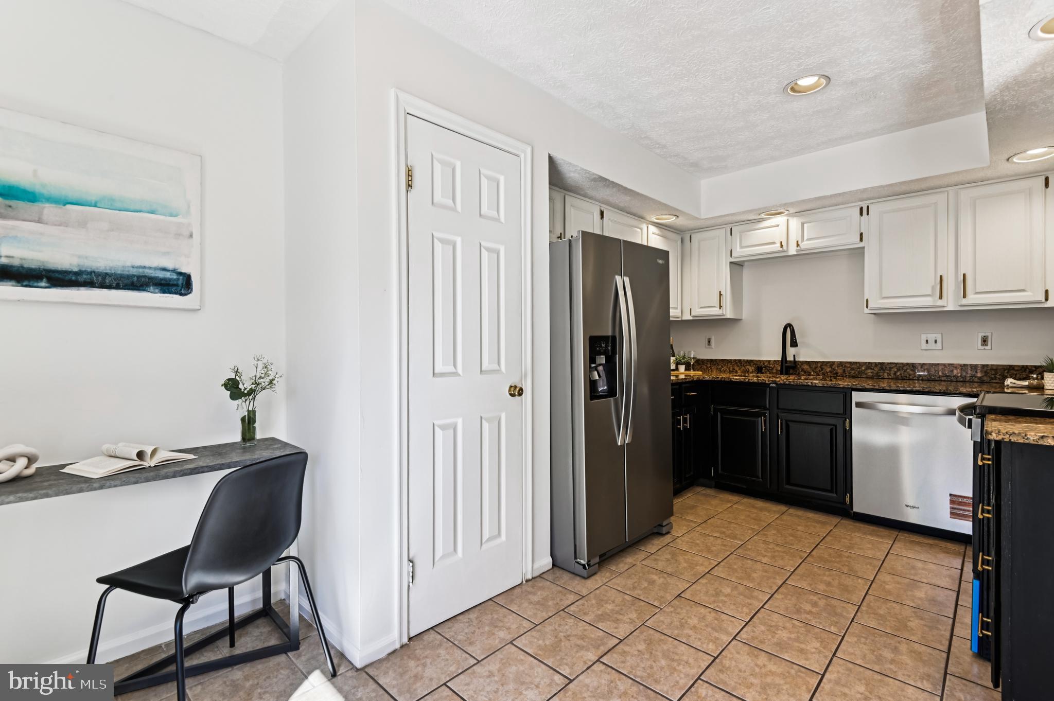 19 Championship Court, Unit K5 Owings Mills, MD 21117 - Photo 6 of 35 a kitchen with granite countertop a refrigerator stove top oven and sink