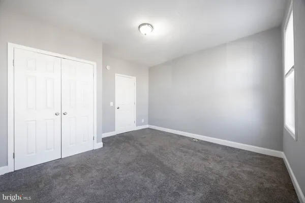 a view of an empty room and a window