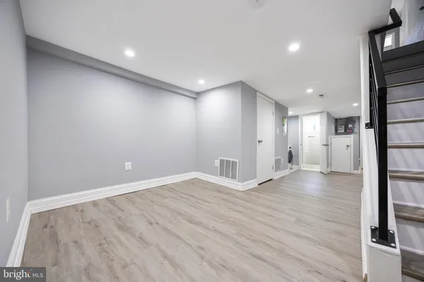 an empty room with wooden floor and a window