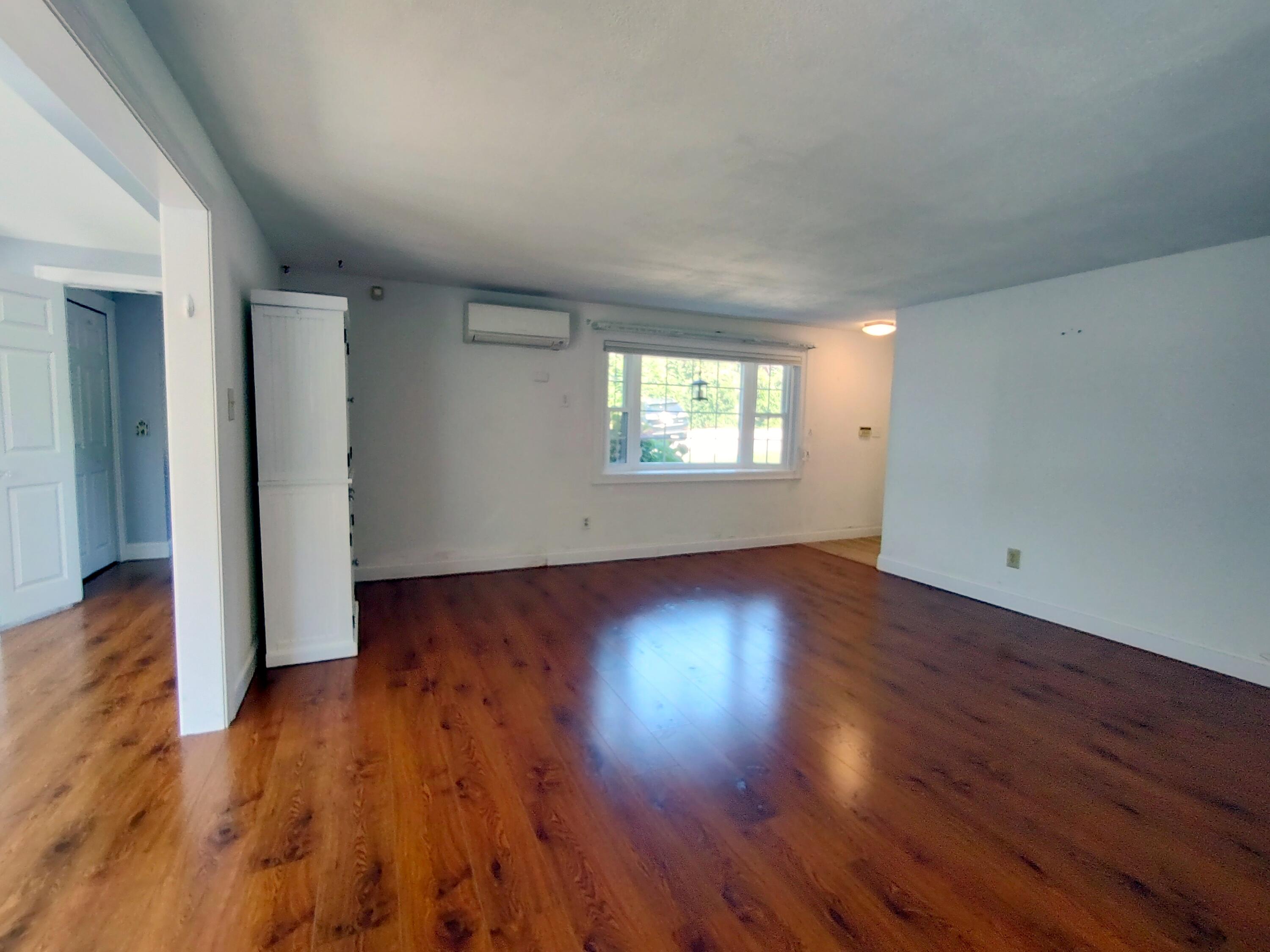 25 Mary-David Road, Unit 50A Yarmouth Port, MA 02675 - Photo 12 of 59 an empty room with wooden floor and windows