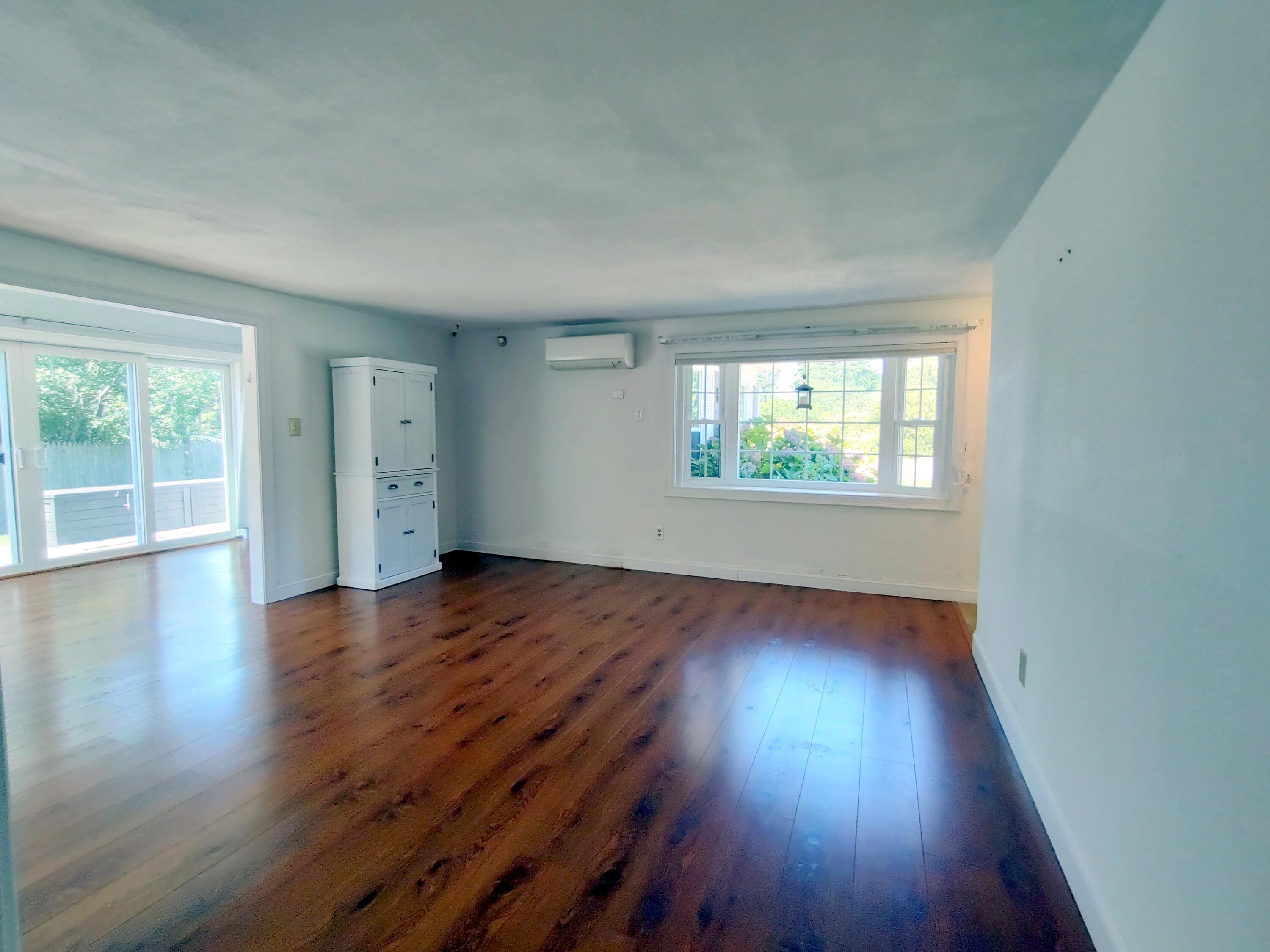 25 Mary-David Road, Unit 50A Yarmouth Port, MA 02675 - Photo 13 of 59 an empty room with wooden floor and windows