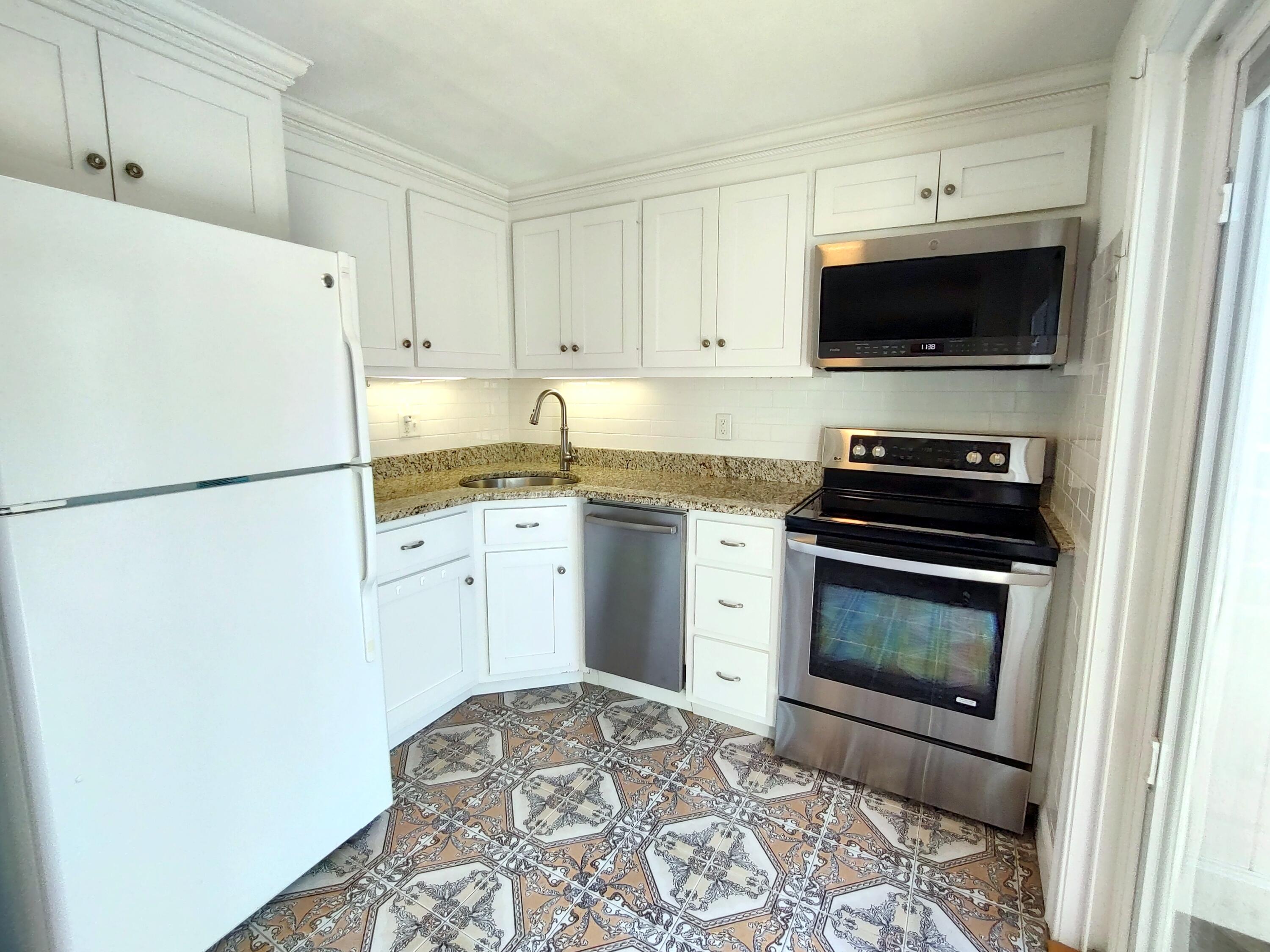 25 Mary-David Road, Unit 50A Yarmouth Port, MA 02675 - Photo 17 of 59 a kitchen with granite countertop a sink stove and refrigerator