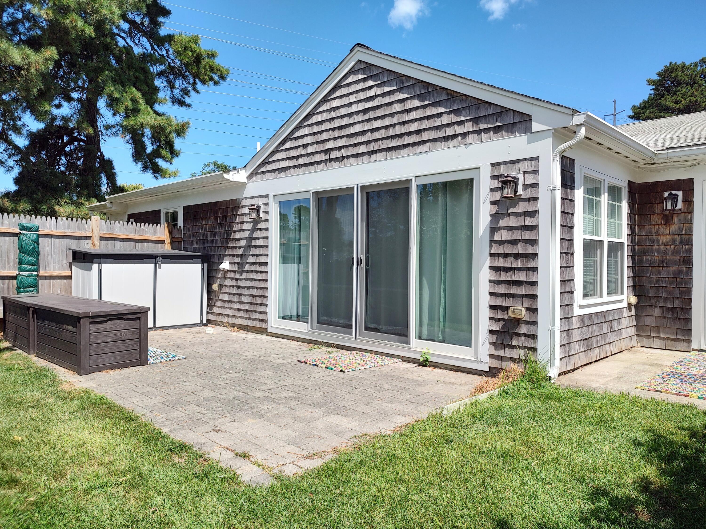 25 Mary-David Road, Unit 50A Yarmouth Port, MA 02675 - Photo 23 of 59 front view of a house with a bench