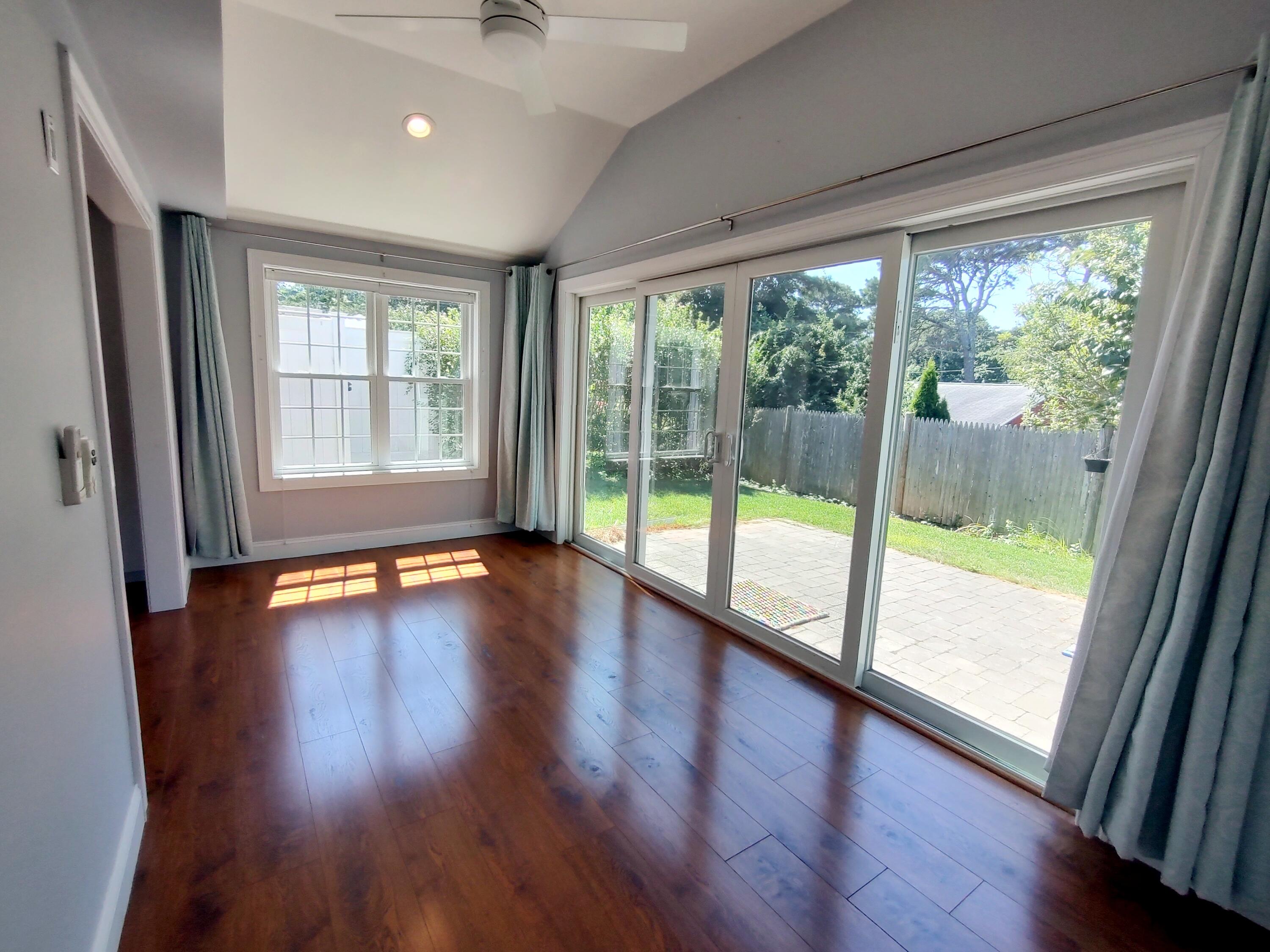 25 Mary-David Road, Unit 50A Yarmouth Port, MA 02675 - Photo 28 of 59 a view of empty room with wooden floor and floor to ceiling window
