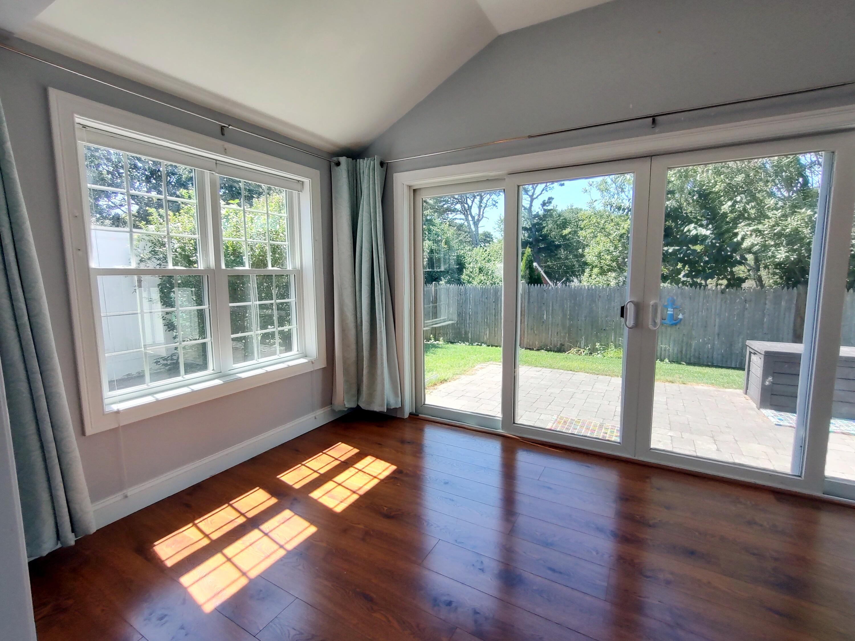 25 Mary-David Road, Unit 50A Yarmouth Port, MA 02675 - Photo 29 of 59 a view of empty room with wooden floor and floor to ceiling window