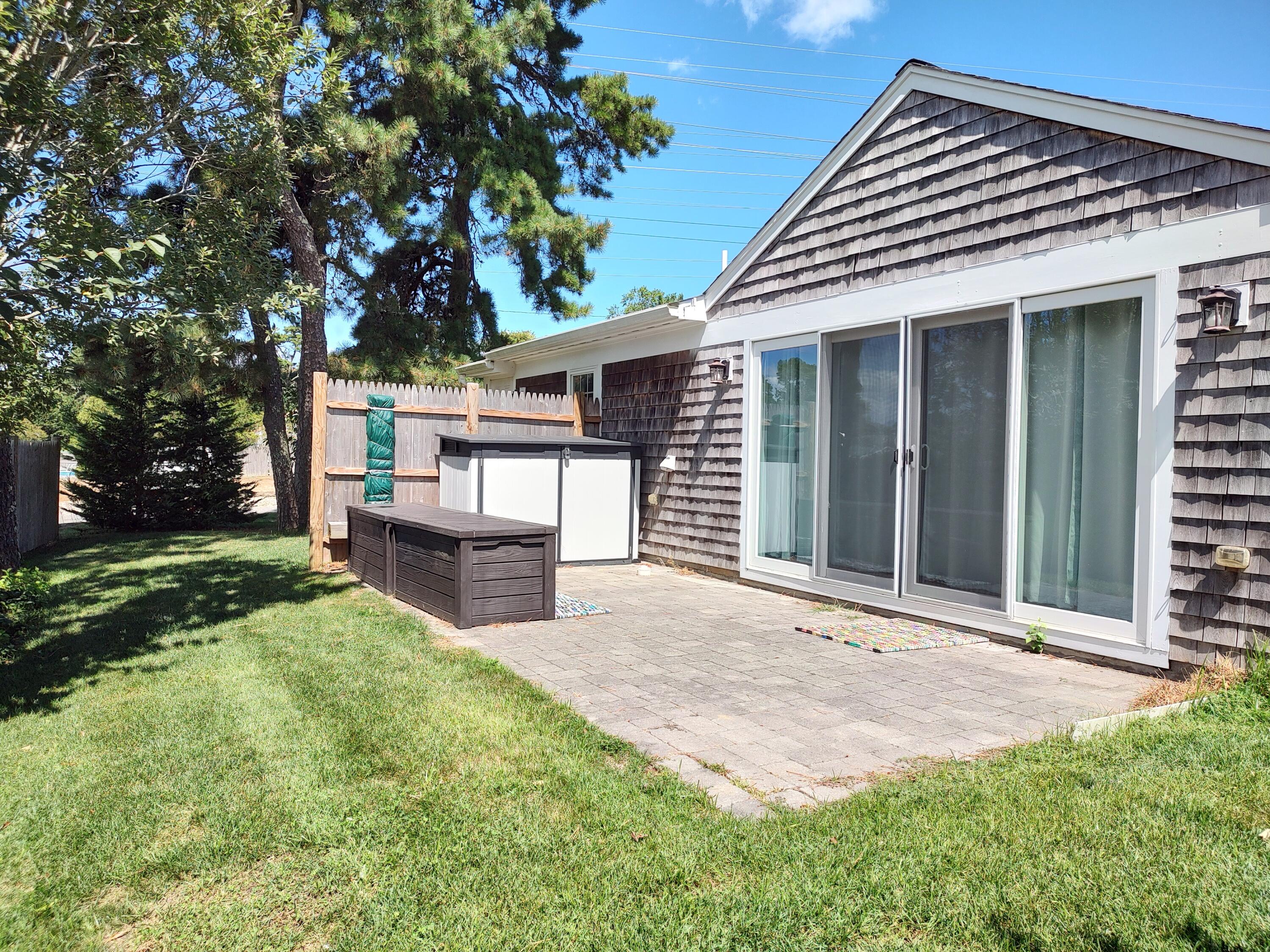 25 Mary-David Road, Unit 50A Yarmouth Port, MA 02675 - Photo 3 of 59 front view of a house with a yard