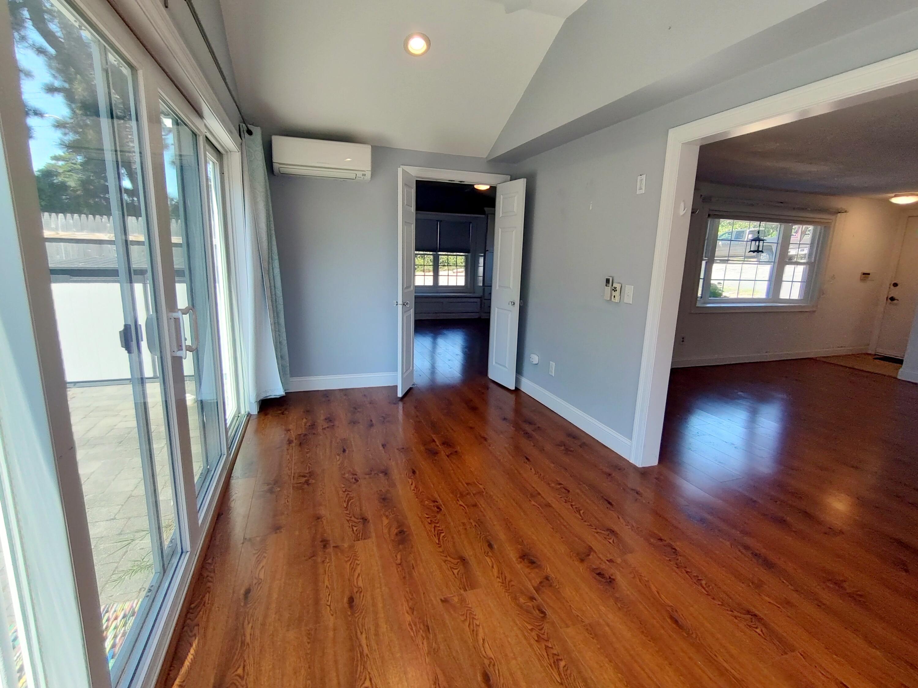25 Mary-David Road, Unit 50A Yarmouth Port, MA 02675 - Photo 31 of 59 a view of an empty room with wooden floor and a window