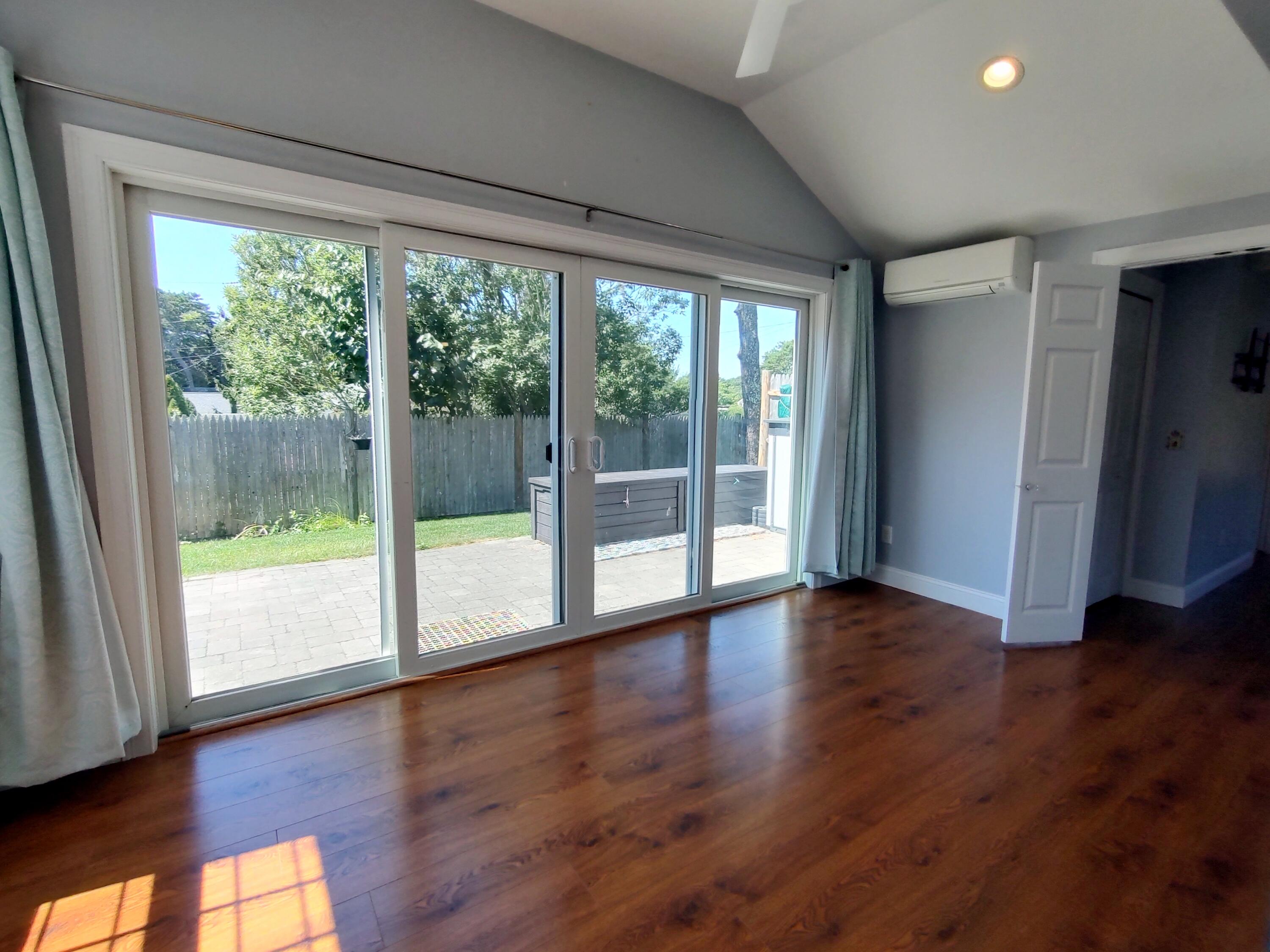 25 Mary-David Road, Unit 50A Yarmouth Port, MA 02675 - Photo 33 of 59 a view of an empty room with wooden floor and doors
