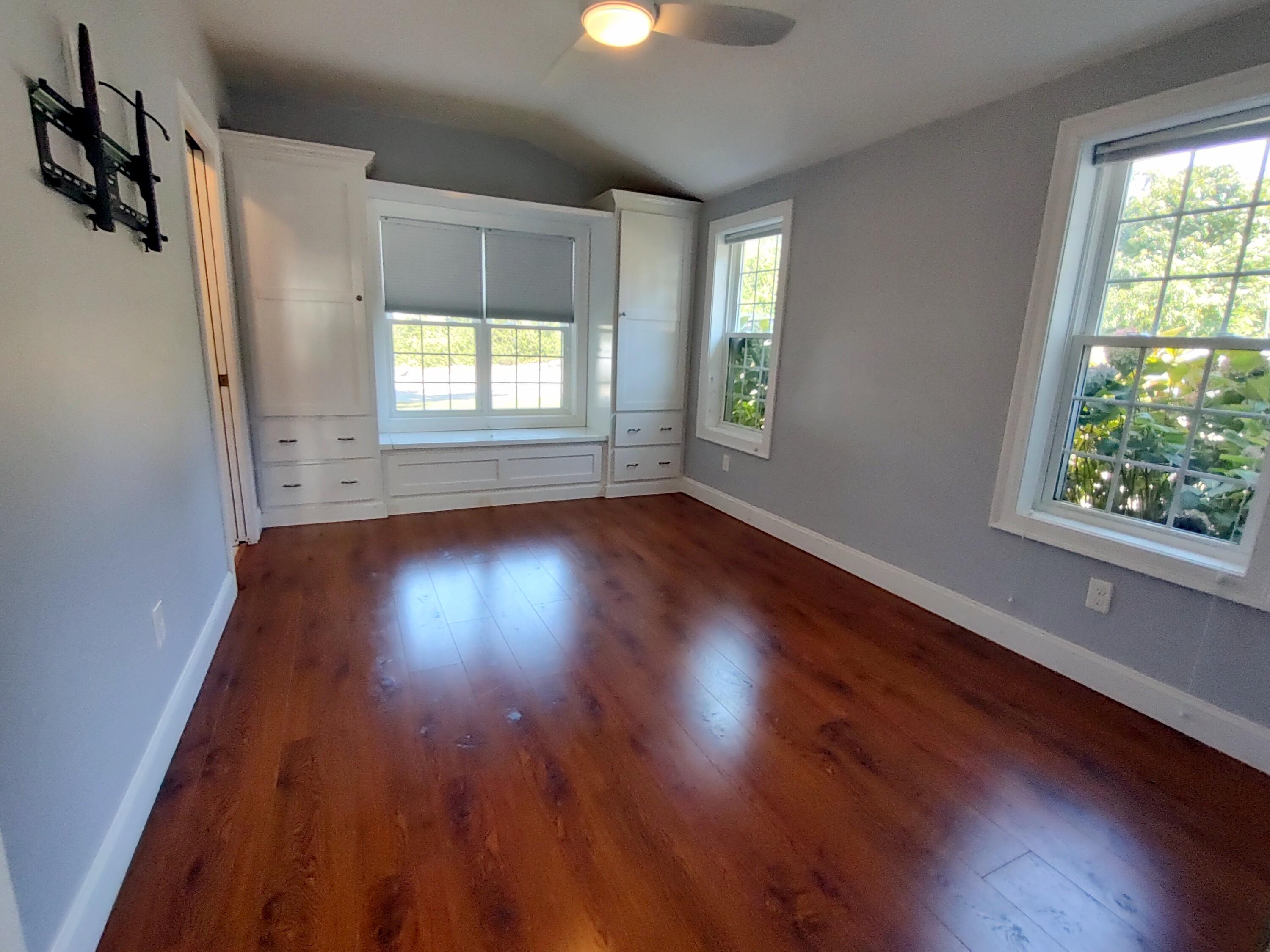 25 Mary-David Road, Unit 50A Yarmouth Port, MA 02675 - Photo 36 of 59 an empty room with wooden floor and windows