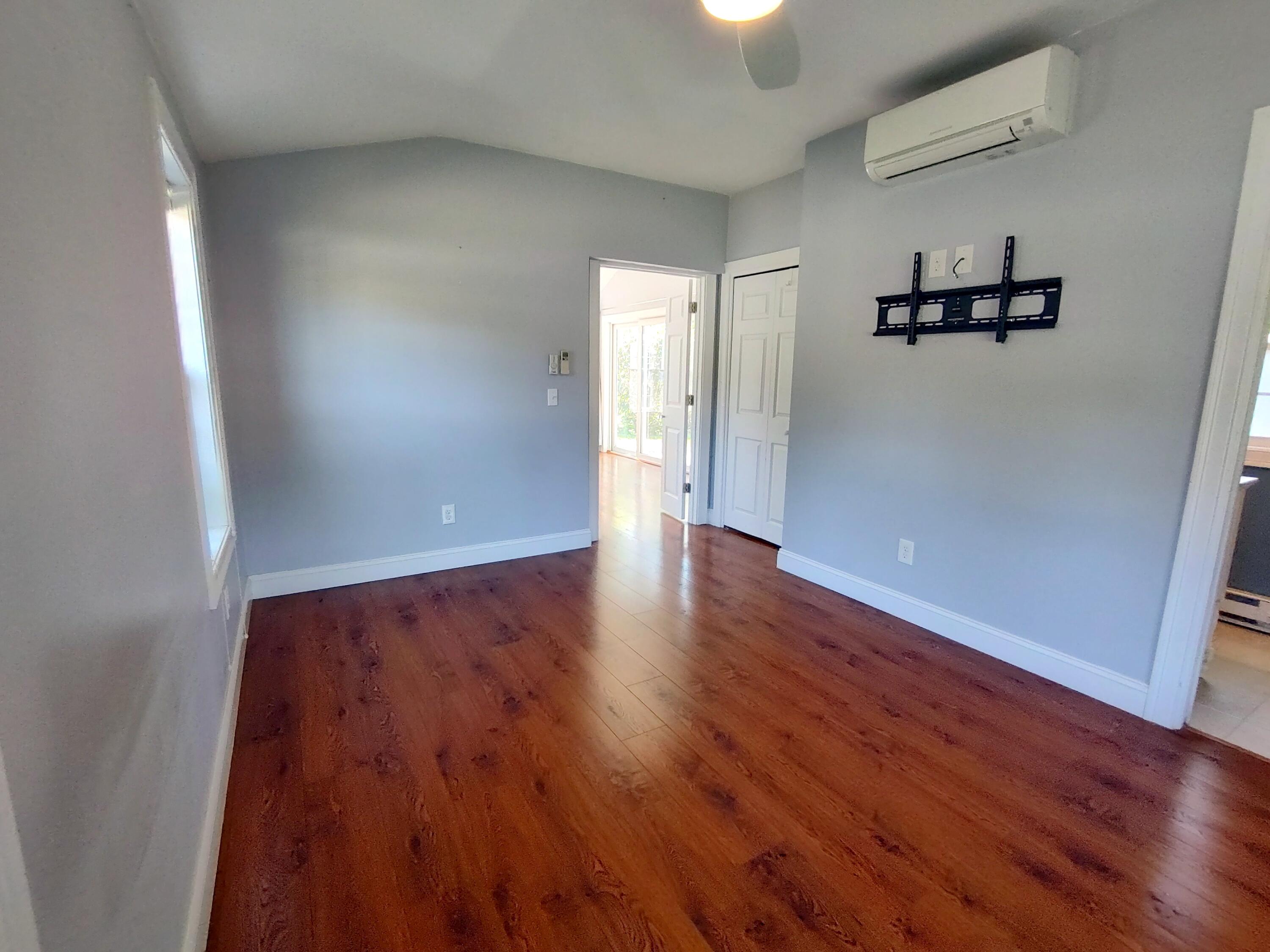 25 Mary-David Road, Unit 50A Yarmouth Port, MA 02675 - Photo 40 of 59 an empty room with wooden floor and windows