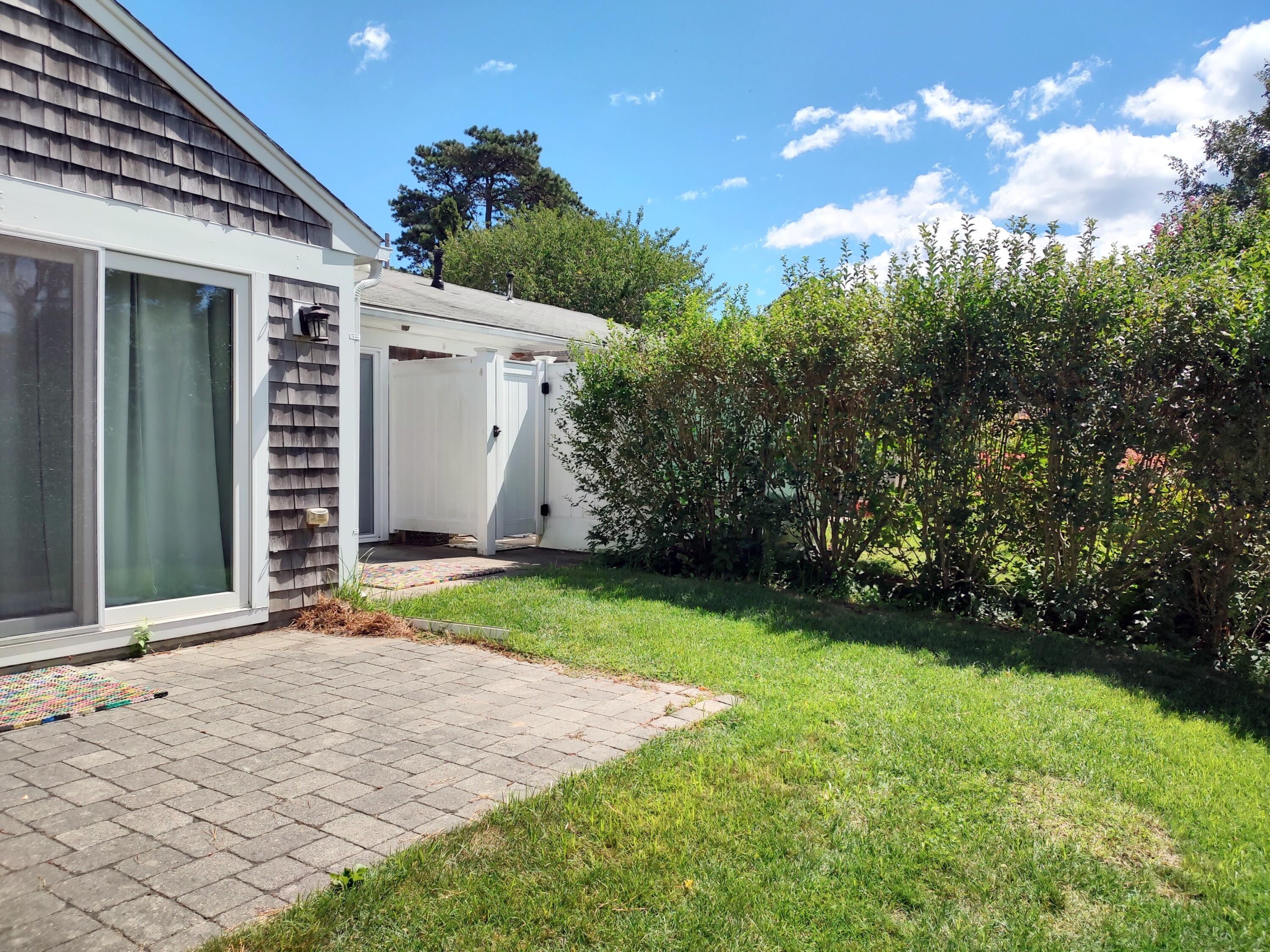 25 Mary-David Road, Unit 50A Yarmouth Port, MA 02675 - Photo 4 of 59 a front view of a house with garden