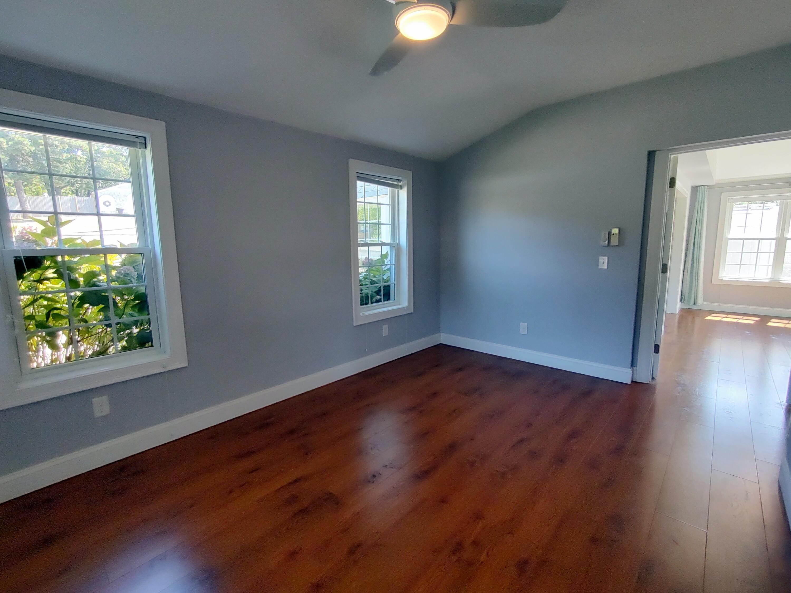 25 Mary-David Road, Unit 50A Yarmouth Port, MA 02675 - Photo 41 of 59 a view of an empty room with wooden floor and a window