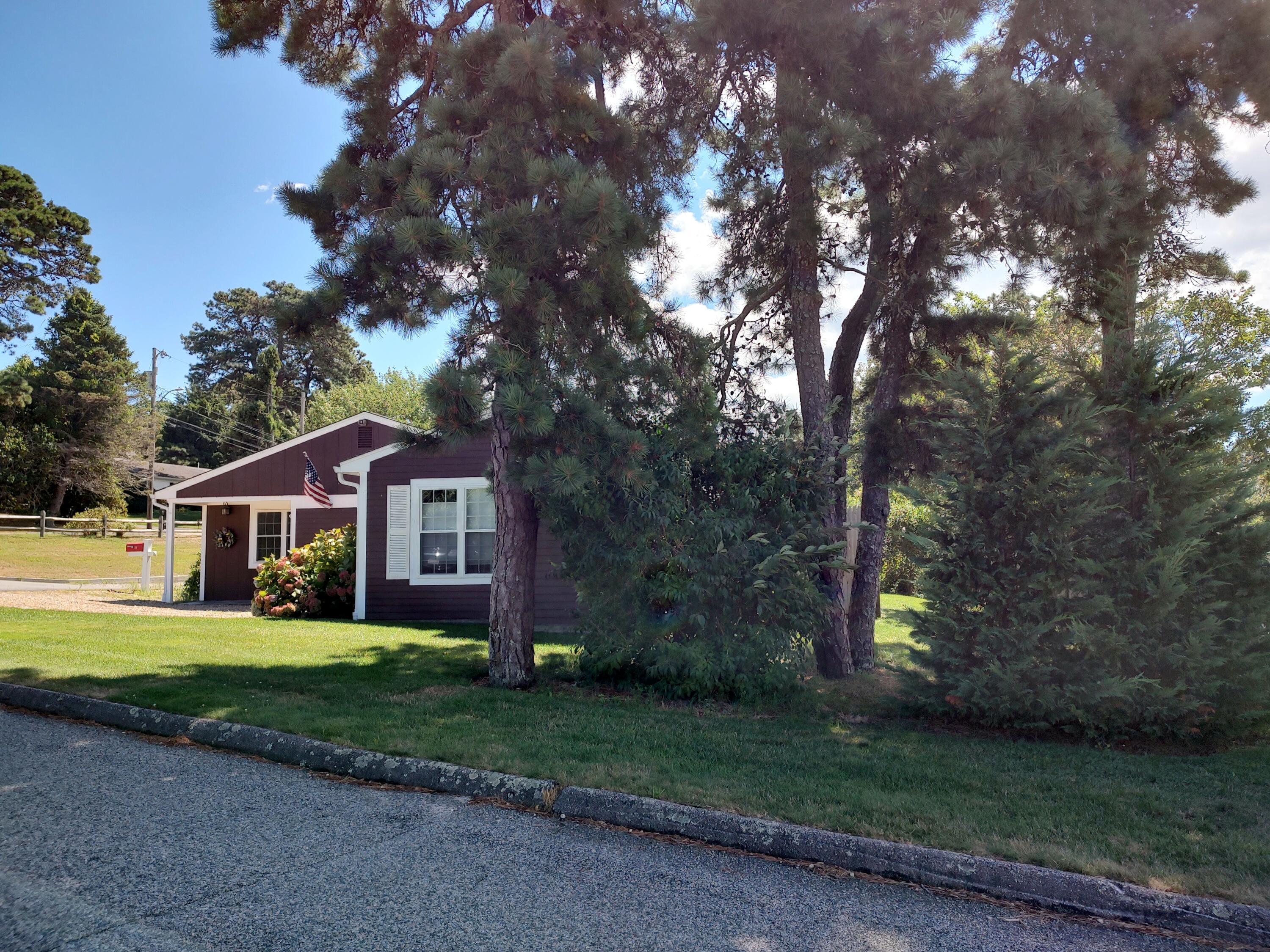 25 Mary-David Road, Unit 50A Yarmouth Port, MA 02675 - Photo 59 of 59 a front view of a house with yard and green space