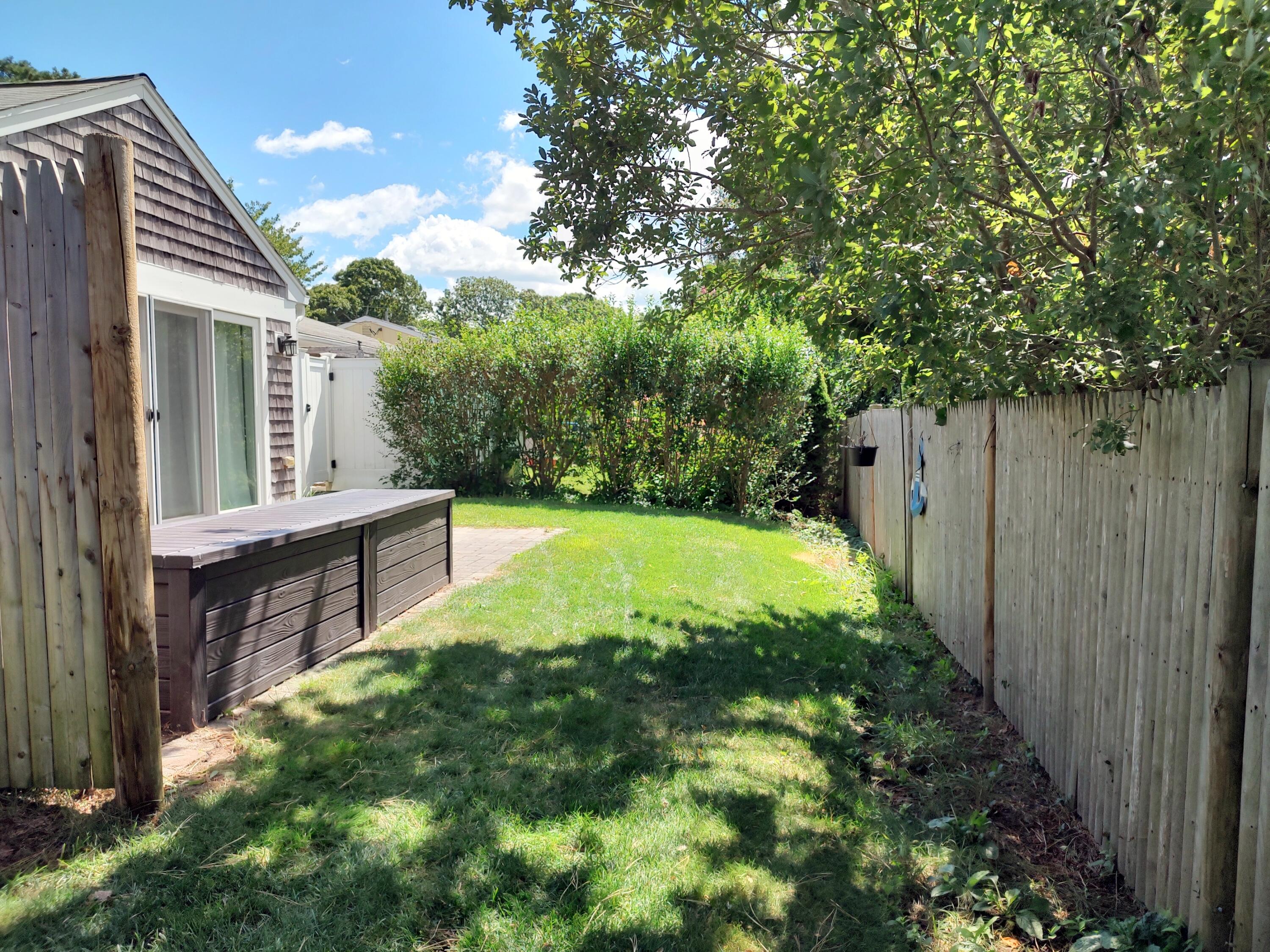 25 Mary-David Road, Unit 50A Yarmouth Port, MA 02675 - Photo 6 of 59 a view of backyard with swimming pool