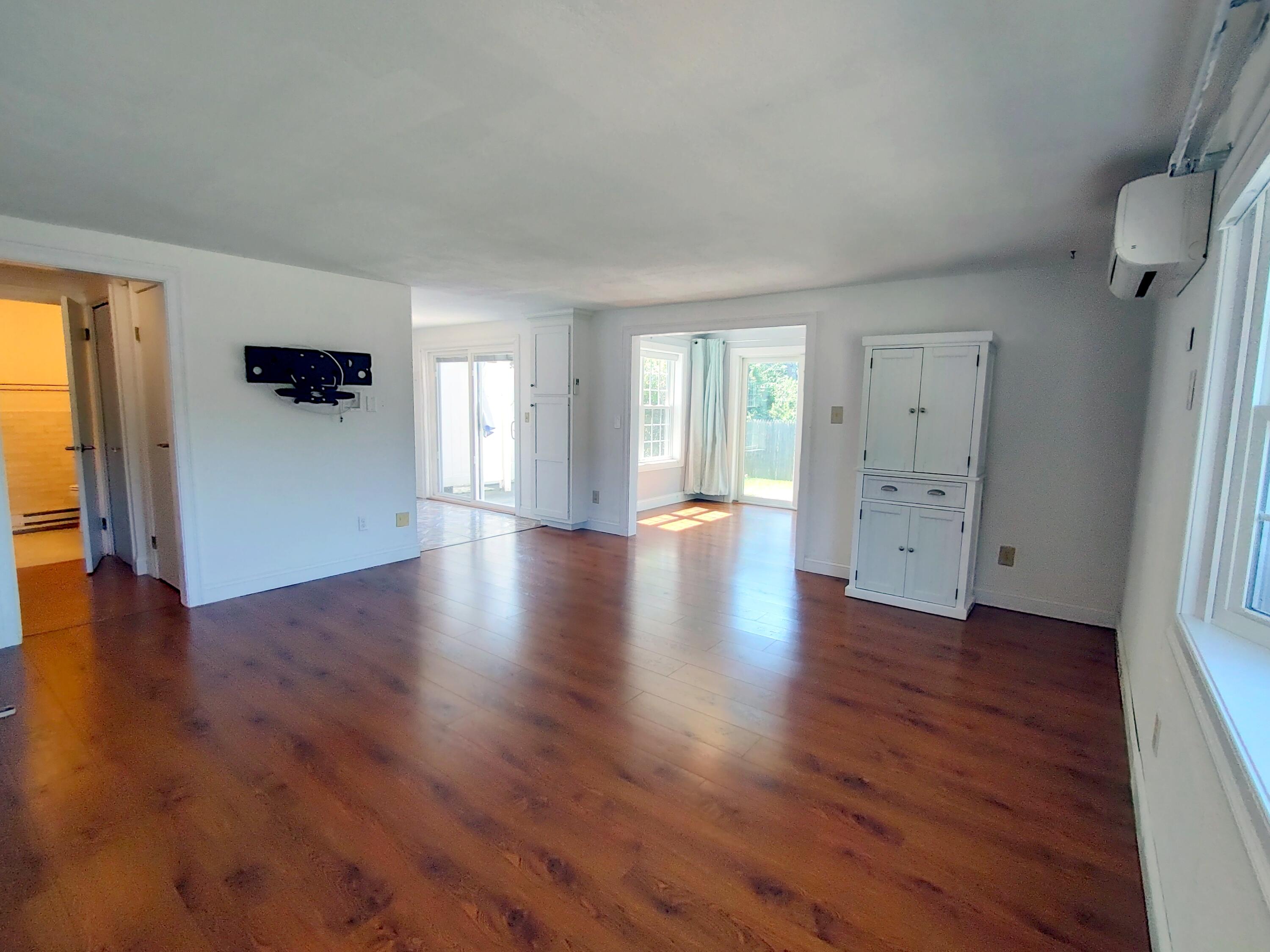 25 Mary-David Road, Unit 50A Yarmouth Port, MA 02675 - Photo 10 of 59 an empty room with wooden floor and windows