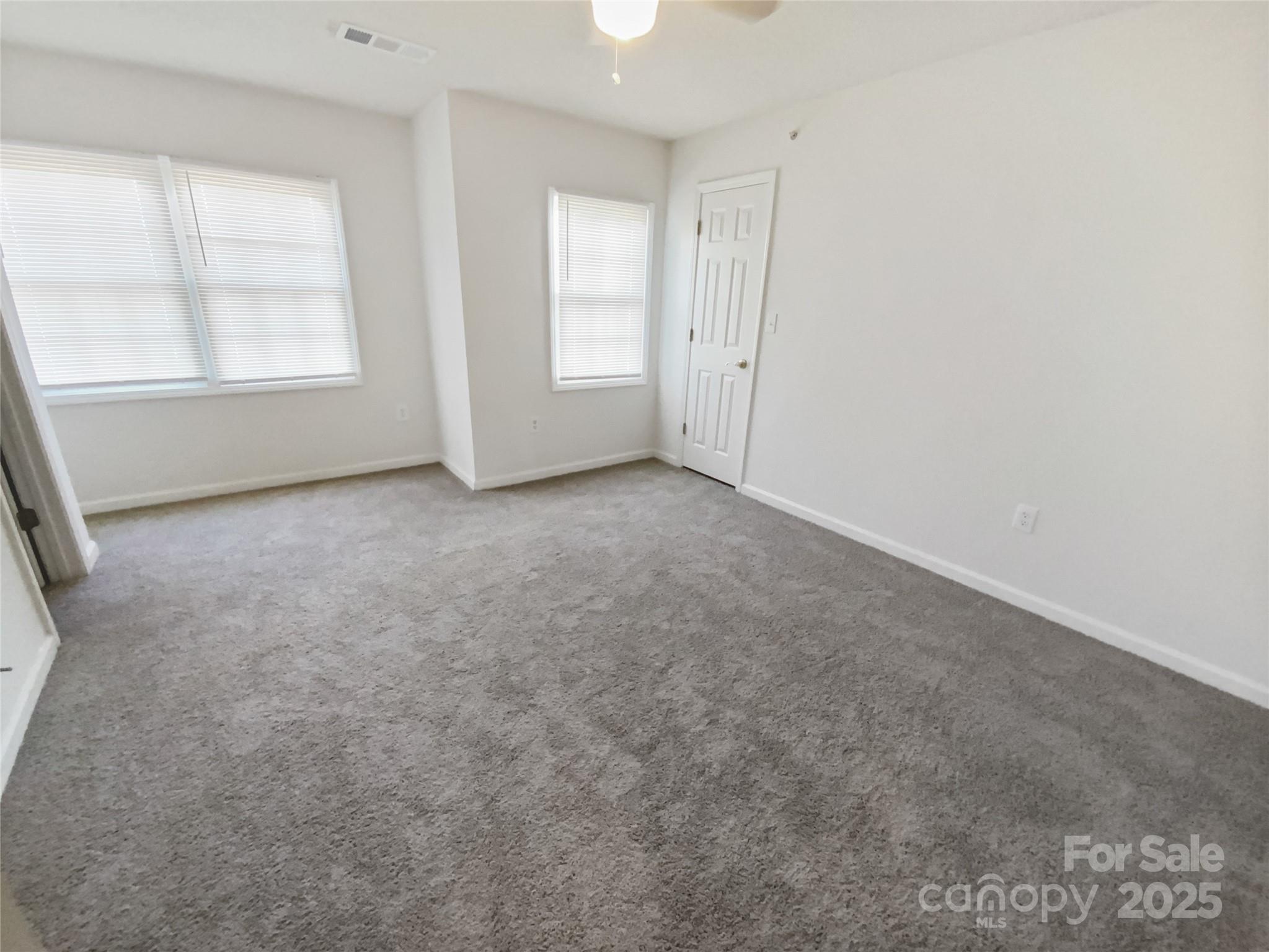 2118 Augusta Street Charlotte, NC 28216 - Photo 14 of 19 an empty room with windows and closet