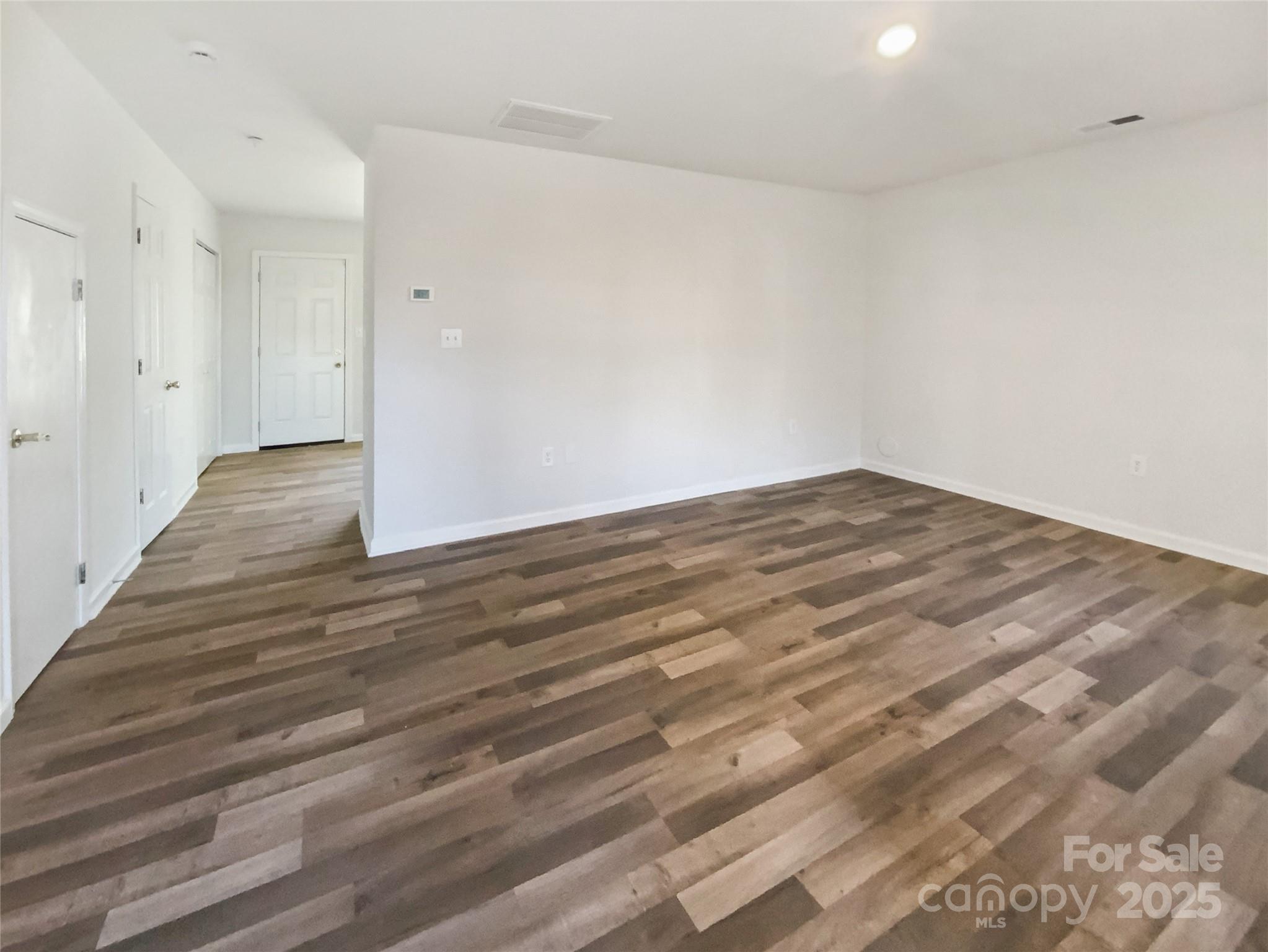 2118 Augusta Street Charlotte, NC 28216 - Photo 18 of 19 a view of empty room with wooden floor