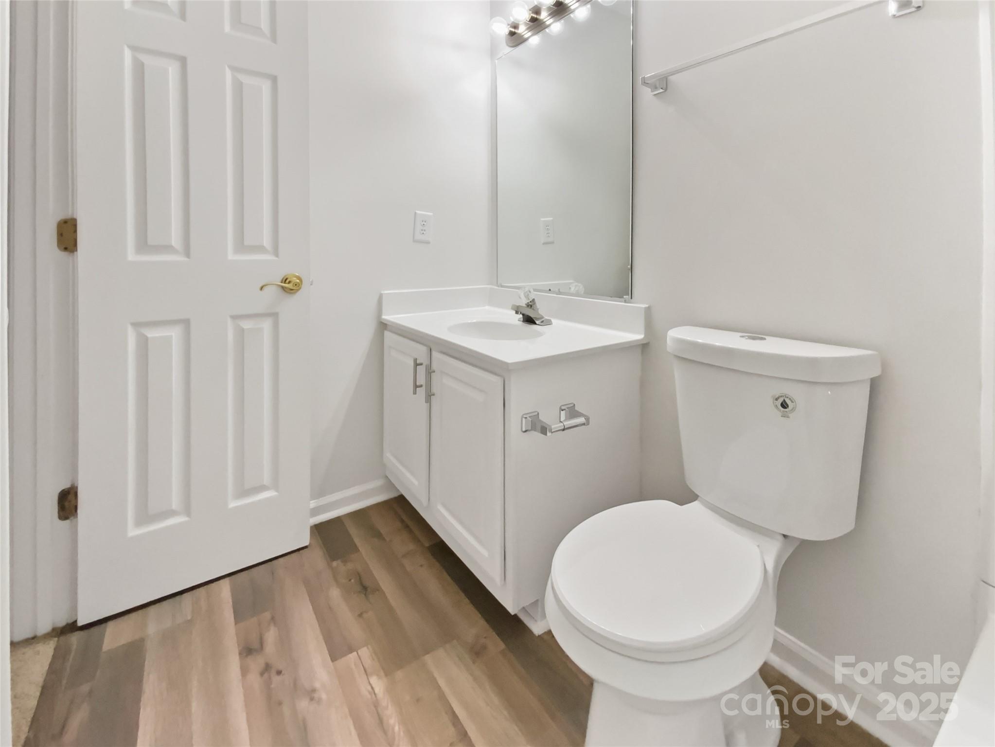 2118 Augusta Street Charlotte, NC 28216 - Photo 6 of 19 a bathroom with a sink a toilet and a mirror