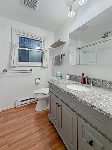 a bathroom with a window and a shower
