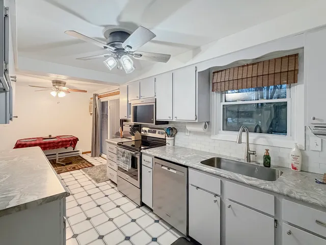 a kitchen with a sink appliances and cabinets