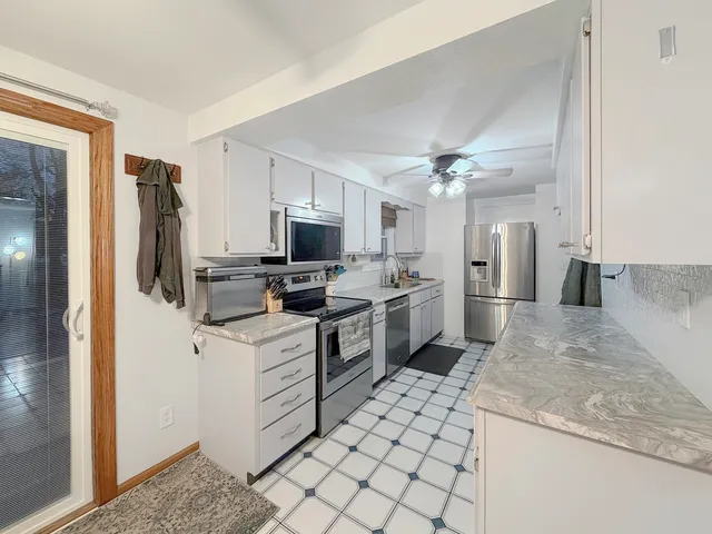 a kitchen with a sink appliances and cabinets