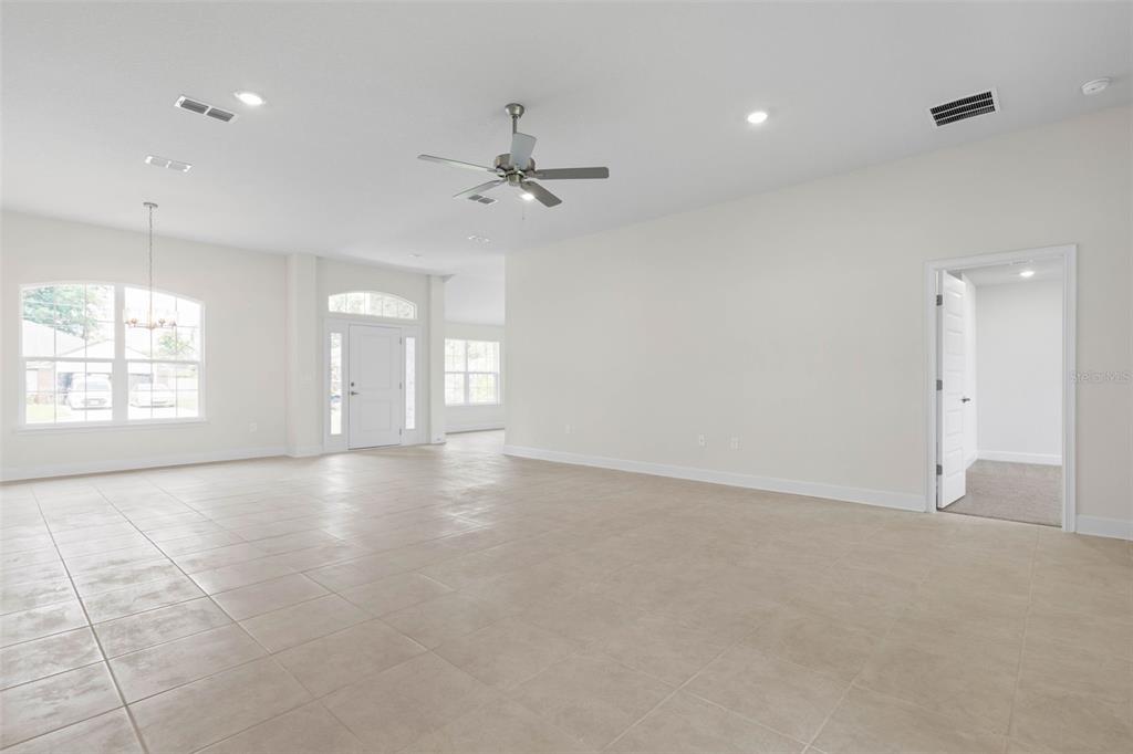 52 Undershire Path Palm Coast, FL 32164 - Photo 11 of 54 an empty room with windows and ceiling fan