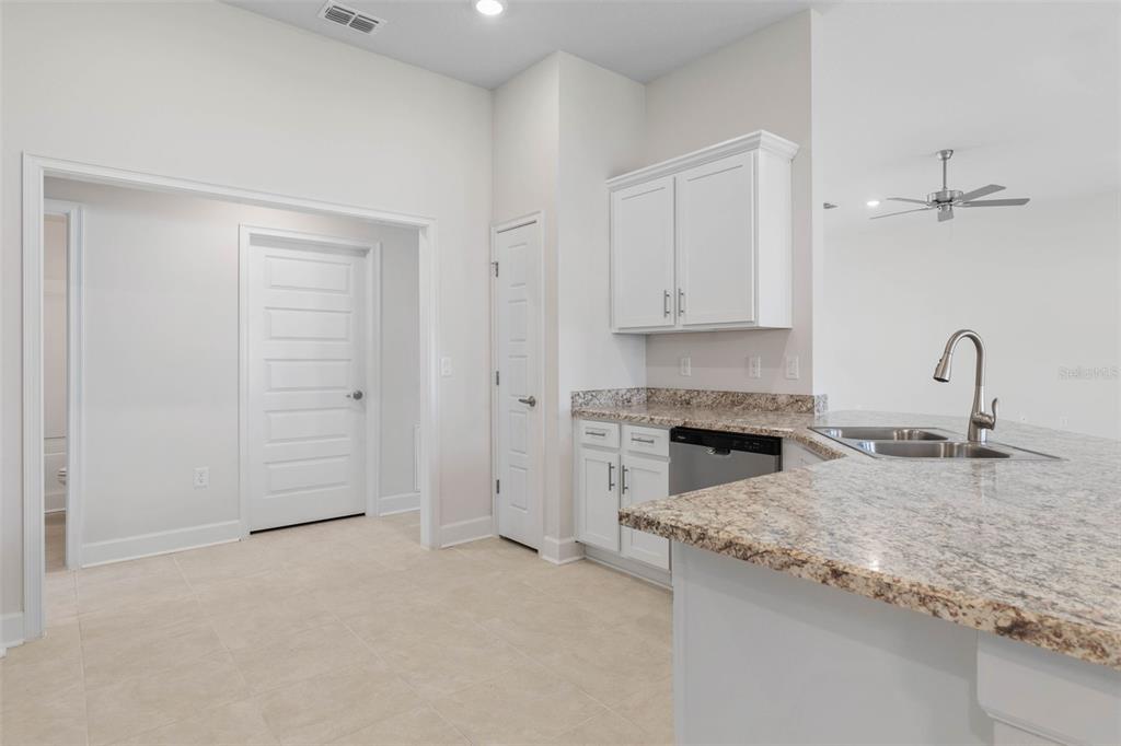 52 Undershire Path Palm Coast, FL 32164 - Photo 15 of 54 a kitchen with granite countertop a sink stainless steel appliances and cabinets