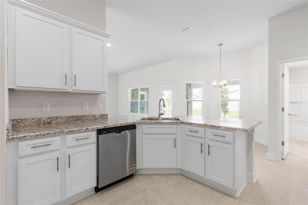 52 Undershire Path Palm Coast, FL 32164 - Photo 16 of 54 a kitchen with white cabinets and sink
