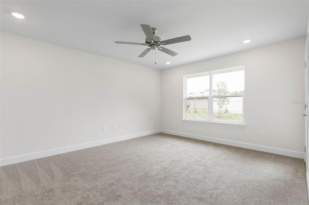 52 Undershire Path Palm Coast, FL 32164 - Photo 19 of 54 an empty room with a window and a fan