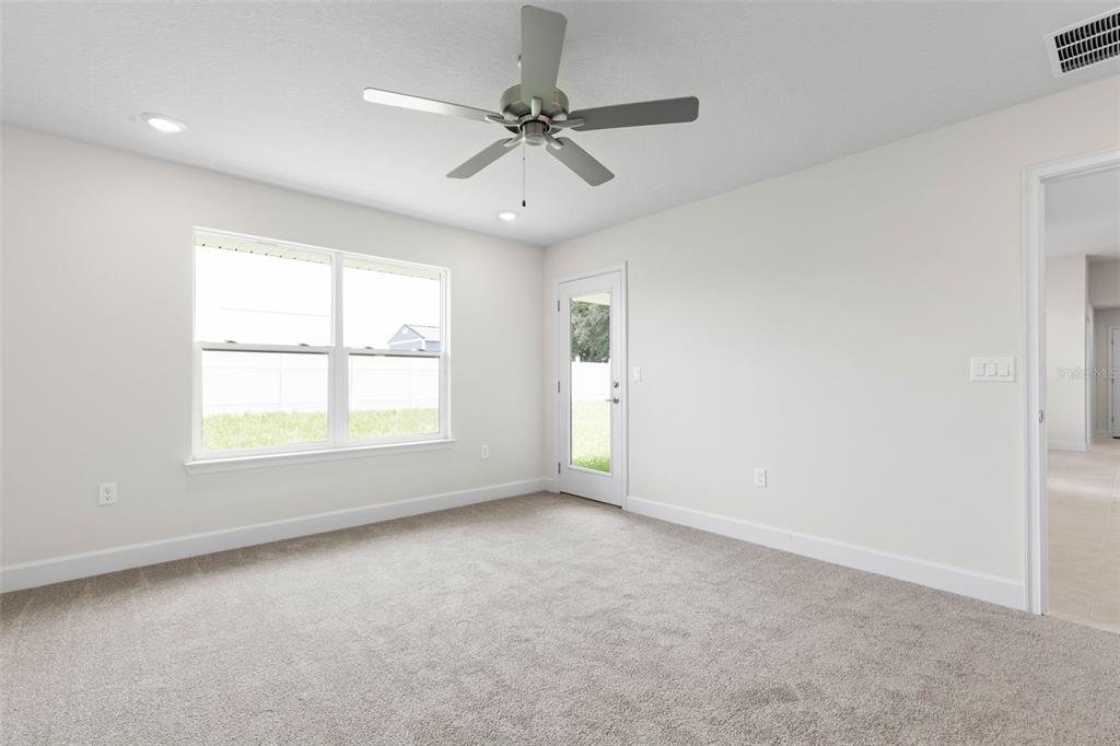 52 Undershire Path Palm Coast, FL 32164 - Photo 20 of 54 an empty room with a window and a fan