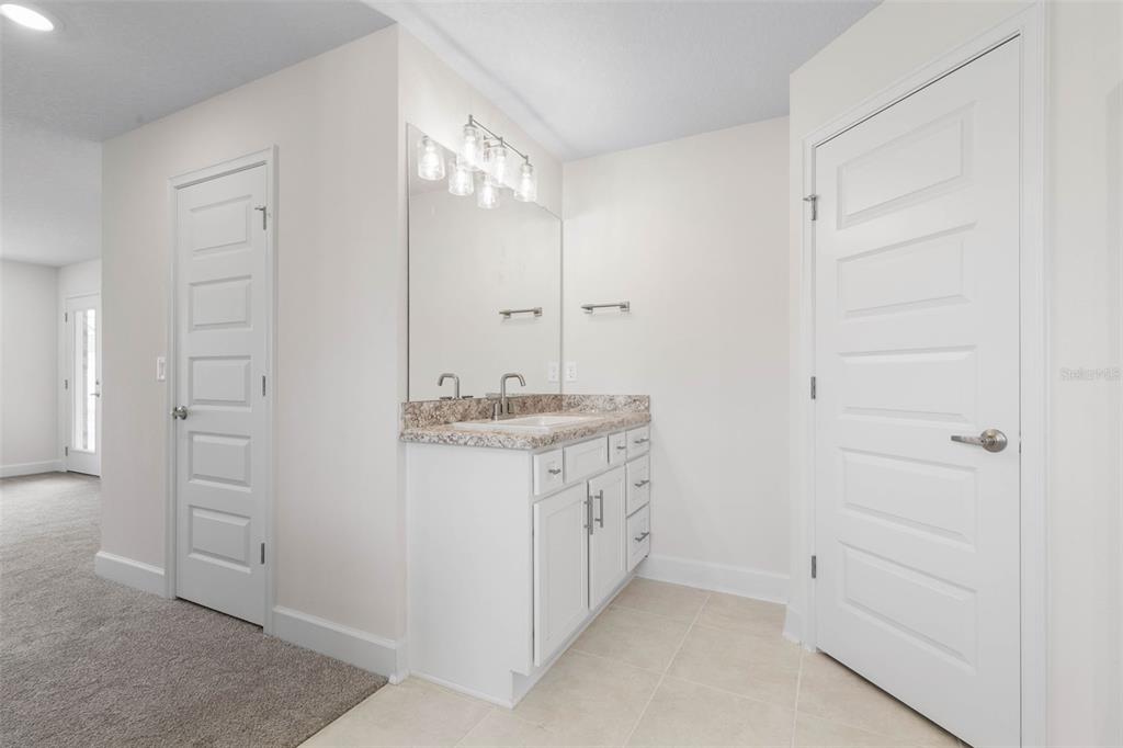 52 Undershire Path Palm Coast, FL 32164 - Photo 23 of 54 a bathroom with a granite countertop sink and a mirror