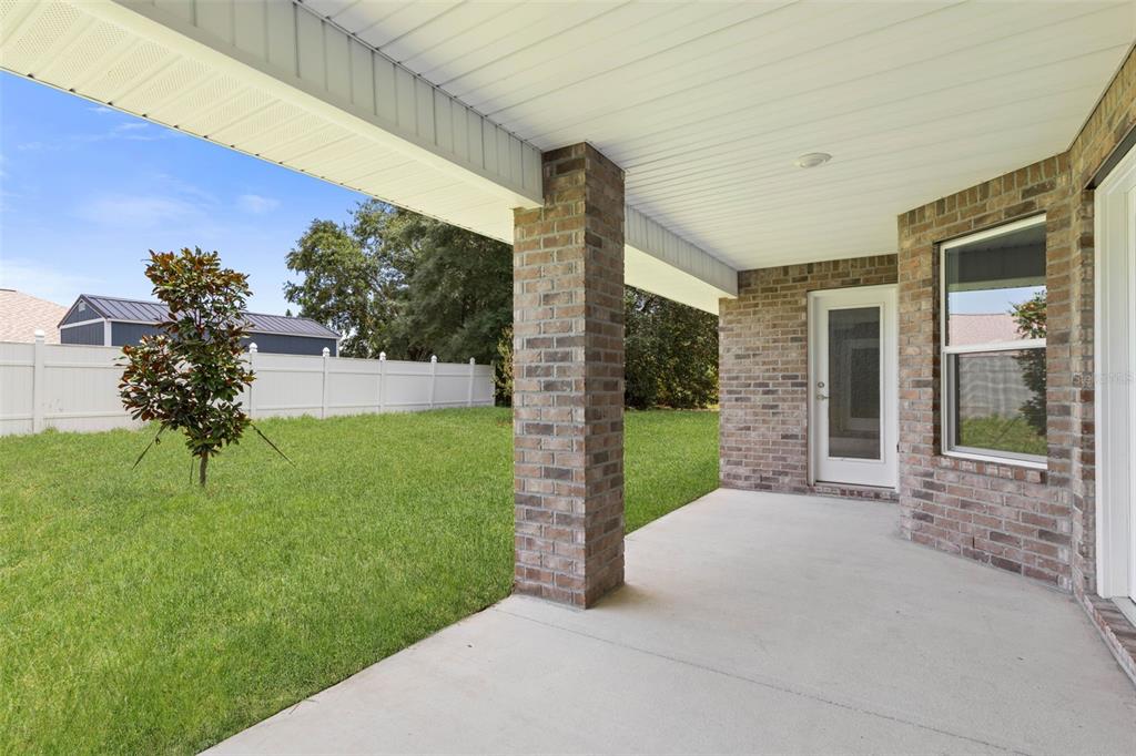 52 Undershire Path Palm Coast, FL 32164 - Photo 38 of 54 a view of a house with a yard and potted plants