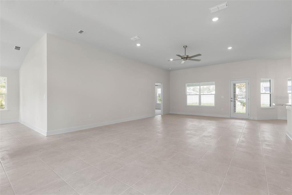 52 Undershire Path Palm Coast, FL 32164 - Photo 5 of 54 an empty room with windows and ceiling fan