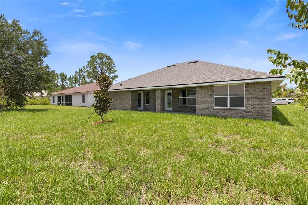 52 Undershire Path Palm Coast, FL 32164 - Photo 52 of 54 a front view of a house with a garden