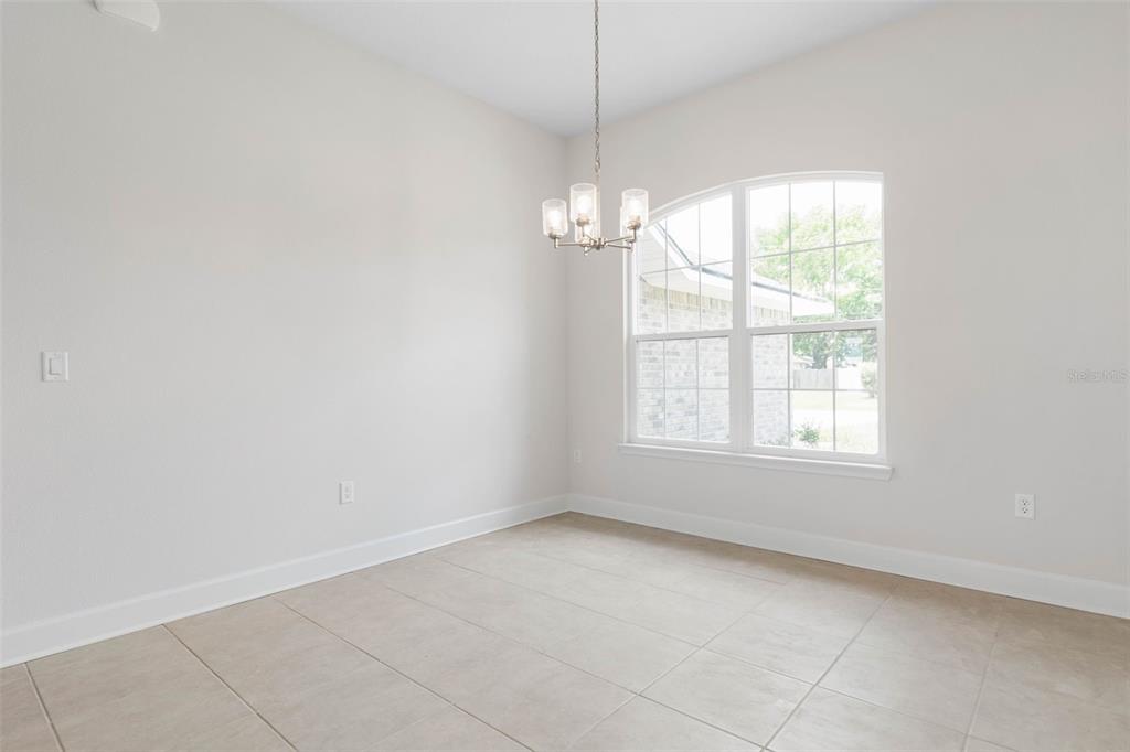 52 Undershire Path Palm Coast, FL 32164 - Photo 9 of 54 an empty room with a windows and chandelier