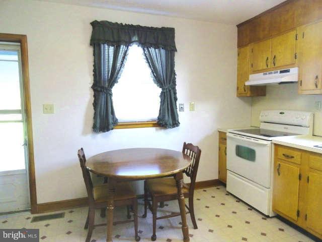 12417 Detour Road Keymar, MD 21757 - Photo 14 of 25 a kitchen with a table and chairs in it