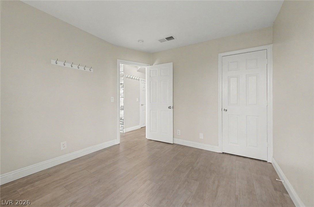 2316 Ramsgate Drive Henderson, NV 89074 - Photo 13 of 28 A well-lit bedroom offering durable, low-maintenance wood-look tile flooring.