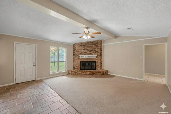 a view of a livingroom with an empty space and a fireplace