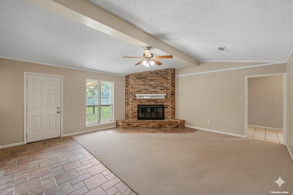 309 Crescent Drive Hewitt, TX 76643 - Photo 4 of 16 a view of an empty room with a fireplace and a window