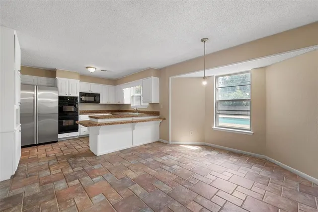 a large kitchen with a large window