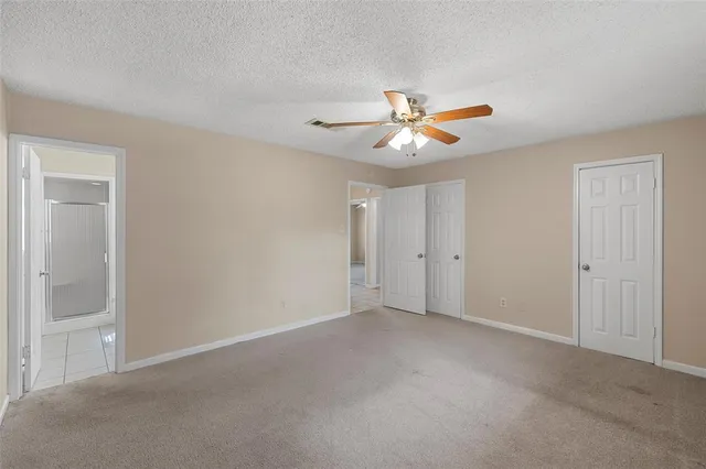 a view of an empty room with a fan