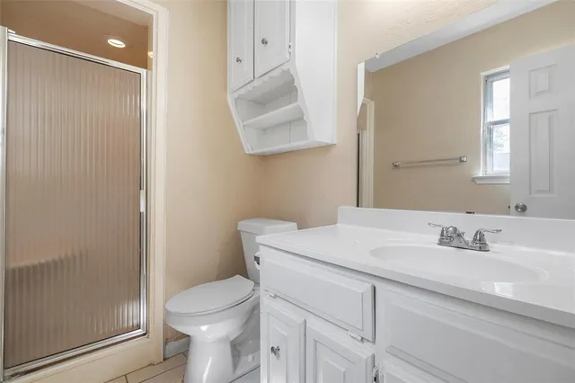 a bathroom with a sink toilet and mirror