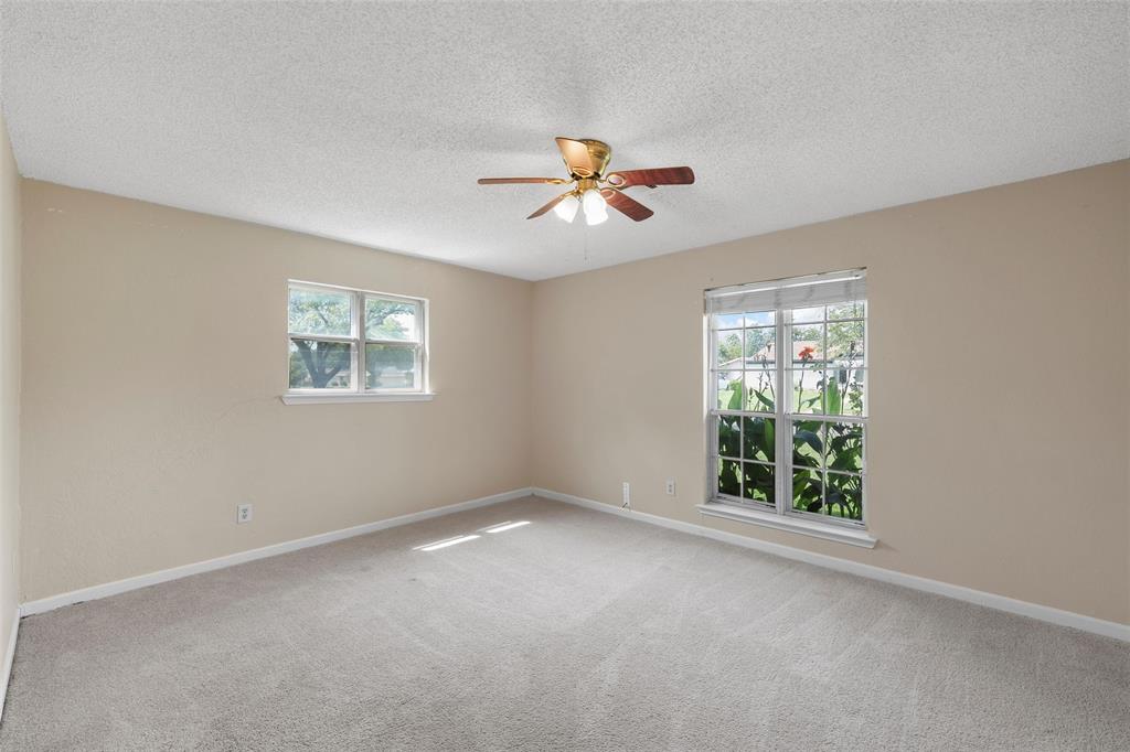 309 Crescent Drive Hewitt, TX 76643 - Photo 10 of 16 an empty room with windows and chandelier fan