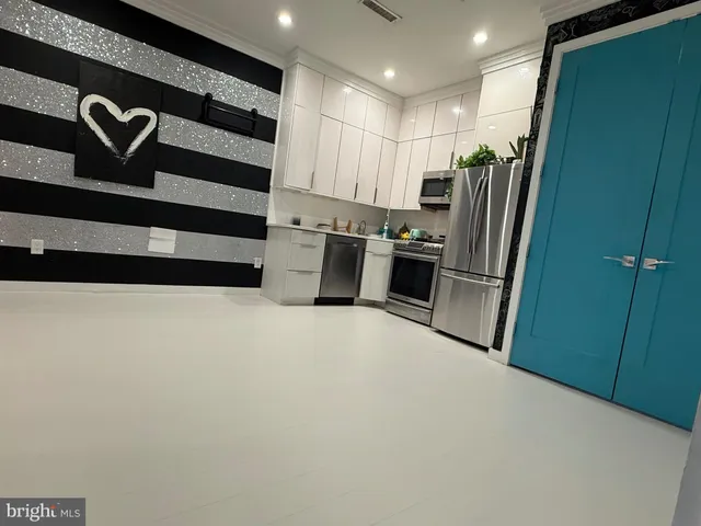 a kitchen with refrigerator and window