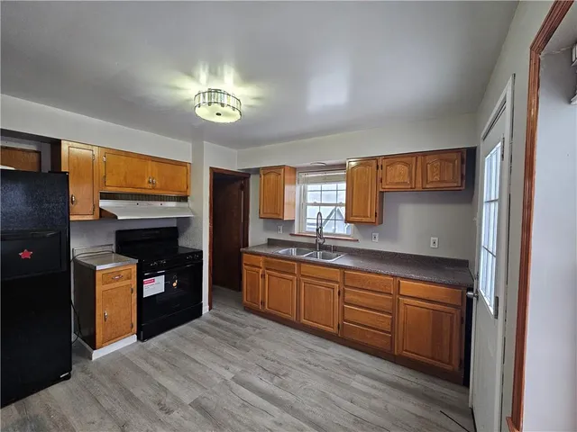 a kitchen with stainless steel appliances granite countertop a stove a sink and a refrigerator