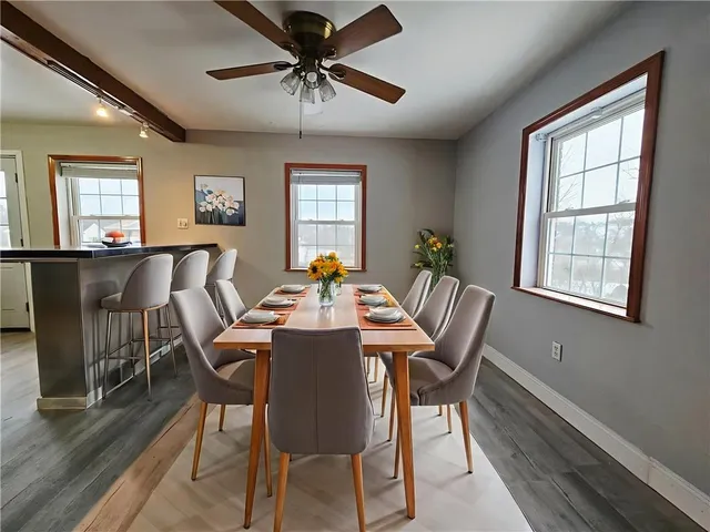 a view of a dining room with furniture window and wooden floor